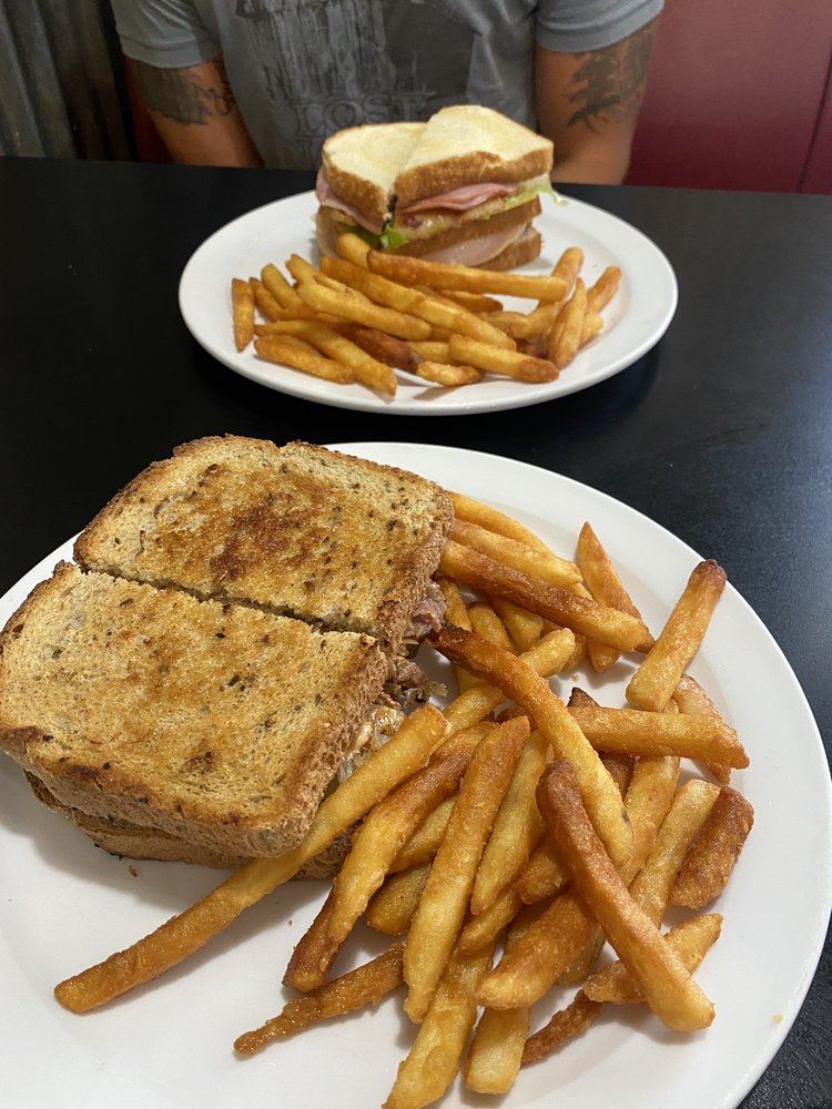 A Reuben and a turkey club with fries